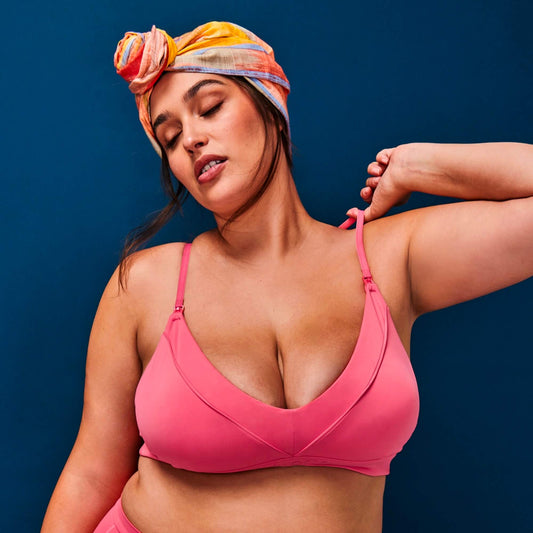 Model has her eyes clothes, snapping her Coral NipCo Maternity Bra with a colourful head turban